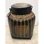 A modern Thai food container of caned form with black lacquered and script decorated panels,
