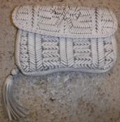 An Anya Hindmarch white leather woven clutch bag with integral bow motif to front