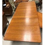 A McIntosh of Glasgow teak rectangular dining table with central leaves, raised on turned supports,