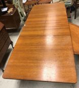 A McIntosh of Glasgow teak rectangular dining table with central leaves, raised on turned supports,