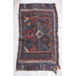 A Persian rug with repeating lozenge medallions in blue, red,