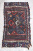 A Persian rug with repeating lozenge medallions in blue, red,