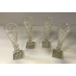 A set of eight hobnail cut glass ale flutes on hobnail cut square bases,