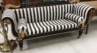 A Victorian ebonised and gilt decorated scroll arm sofa in the Empire taste,