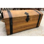 A modern teak dome top trunk as a treasure chest,