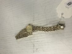 A ladies Accurist "gold" dress watch with 9 carat gold fancy chainlink bracelet, approx.