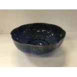 A modern blue glazed fruit bowl of lobed form, indistinctly signed and dated '91 to the base,