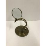 A modern brass table magnifying glass,