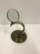 A modern brass table magnifying glass,