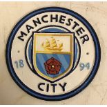 A modern painted cast metal sign "Manchester City",