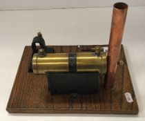 A scratch built copper and brass stationary steam engine with electric bulb, on an oak base,