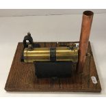 A scratch built copper and brass stationary steam engine with electric bulb, on an oak base,