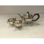A George V silver tea set with beaded decoration raised on a circular foot (Birmingham 1933 by
