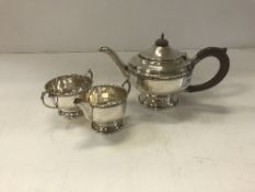 A George V silver tea set with beaded decoration raised on a circular foot (Birmingham 1933 by
