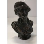 A patinated bronze bust of a classical maiden signed verso within the casting “V Carrier”,