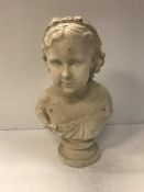 An early 20th Century painted plaster bust of a young girl with bow in her hair,