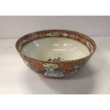 A Qianlong polychrome decorated famille rose bowl with all over decoration of figures in garden