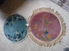 Two small circular Chinese Art Deco style rugs, one with prunus blossom decoration on a pink ground,