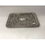 An Edwardian embossed silver rectangular tray with all over scrolling foliate and floral decoration