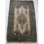 A Caucasian rug with centre medallion on a cream stylised tarantula decorated and foliate ground,