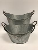 Two large galvanised oval planters and two smaller to match