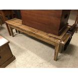 A waxed and stained pine bench seat in t