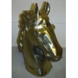 A gold coloured cast aluminium horse hea