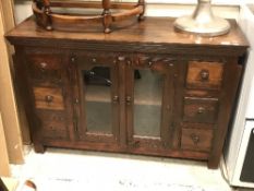 A modern teak sideboard with two glazed