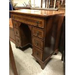 A burr walnut kneehole desk in the early