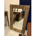 A rustic pine rectangular framed wall mi