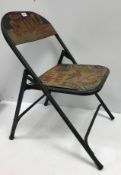 A painted metal folding chair inscribed "Billie Smart's Circus Britain's Greatest"