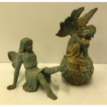 A verdigris patinated figure of an angel sat upon a flower ball and another seated with dove upon