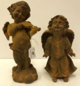 A cast iron figure of a cherub playing the violin,