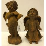 A cast iron figure of a cherub playing the violin,
