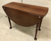 A mahogany oval drop-leaf dining table i