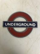 A modern painted cast metal sign "Underg
