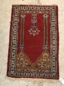 A Bokhara rug the central panel set with