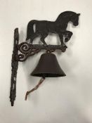 A painted cast metal "Heavy Horse" bell