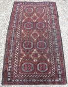 A Turkamen tribal rug with repeating ele