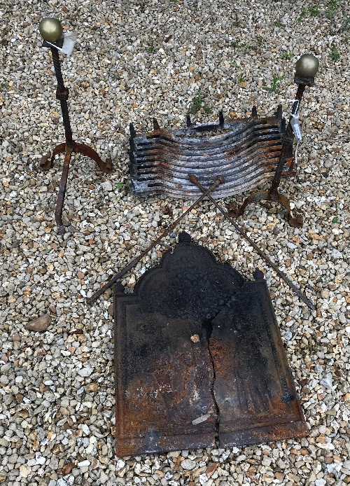 A cast iron fire back decorated with mal