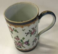 A Chinese style cylindrical mug with fam