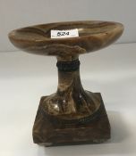 A brown onyx urn with silvered metal emb