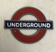 A modern painted cast metal sign "Underg