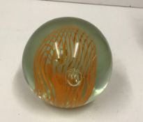 A modern paperweight with orange interna