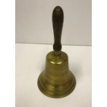 A reproduction brass school hand bell wi