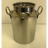 A stainless steel milk churn