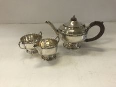 A George V silver tea set with beaded de