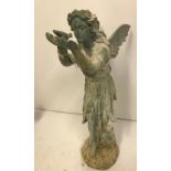 A cast iron figure of a fairy with shell