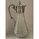 An early 20th Century cut glass pear shaped claret jug with silver plated mounts by Hukin & Heath