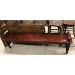 A mahogany window seat in the Victorian manner, the plain top with turned and ringed side handles,